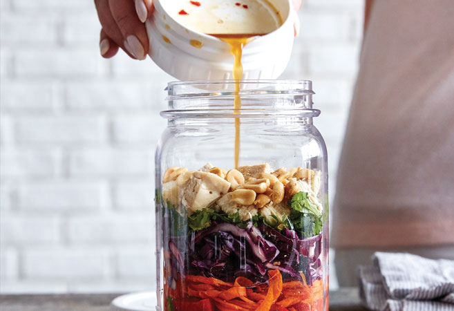 Salad Dressing Being Poured Into a Jar