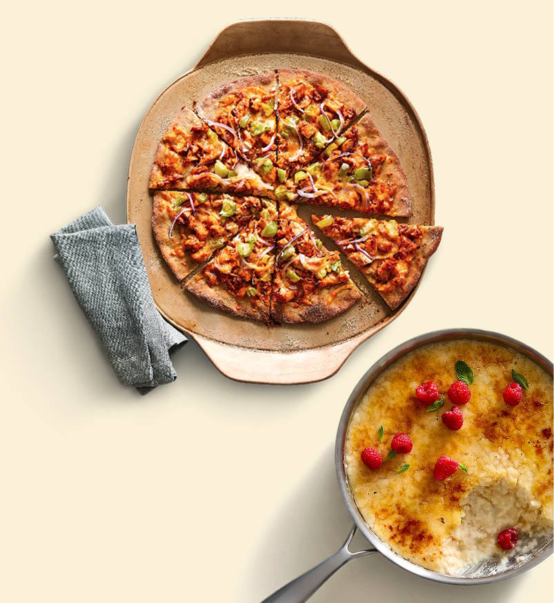 Pizza on stoneware, food cooked in a stainless steel pan