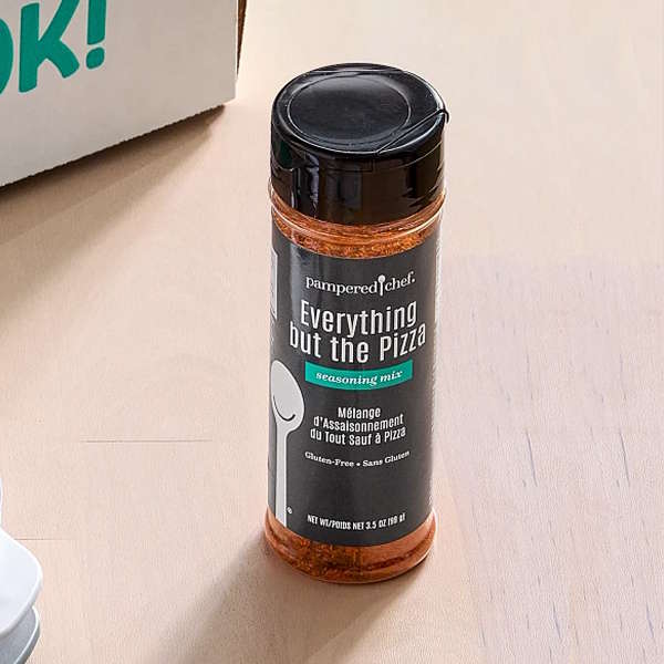 A full-size Everything but the Pizza Seasoning bottle on a countertop.