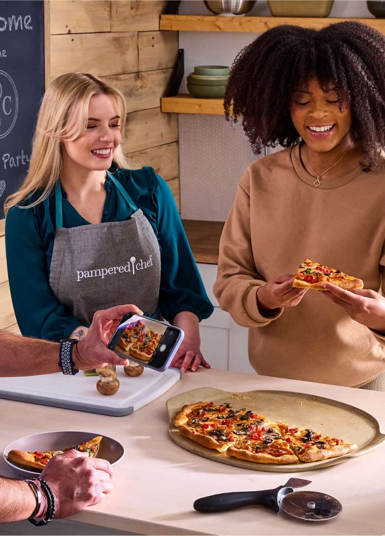 Consultant and party host sharing a pizza