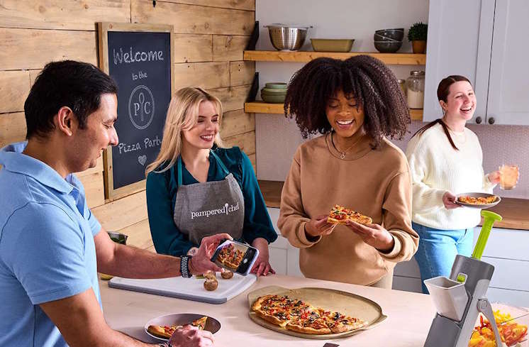 Consultant and party host sharing a pizza