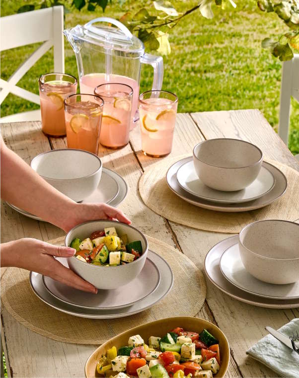 serving salad and lemonade on a table outdoors