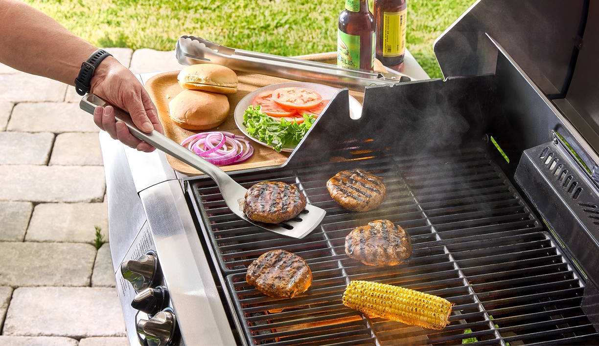 Various products on a grill making burgers representing the sale